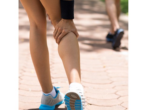 A runner holding the back of the knee