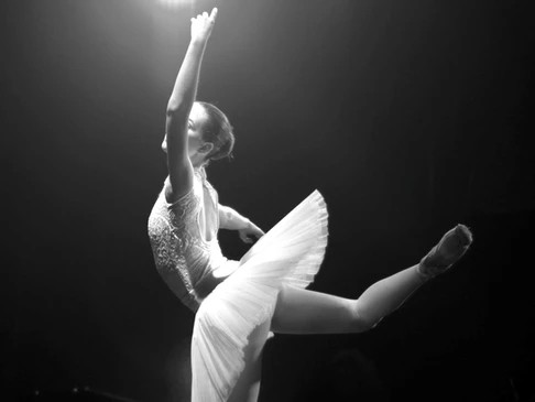 ballerina dancing under a spotlight